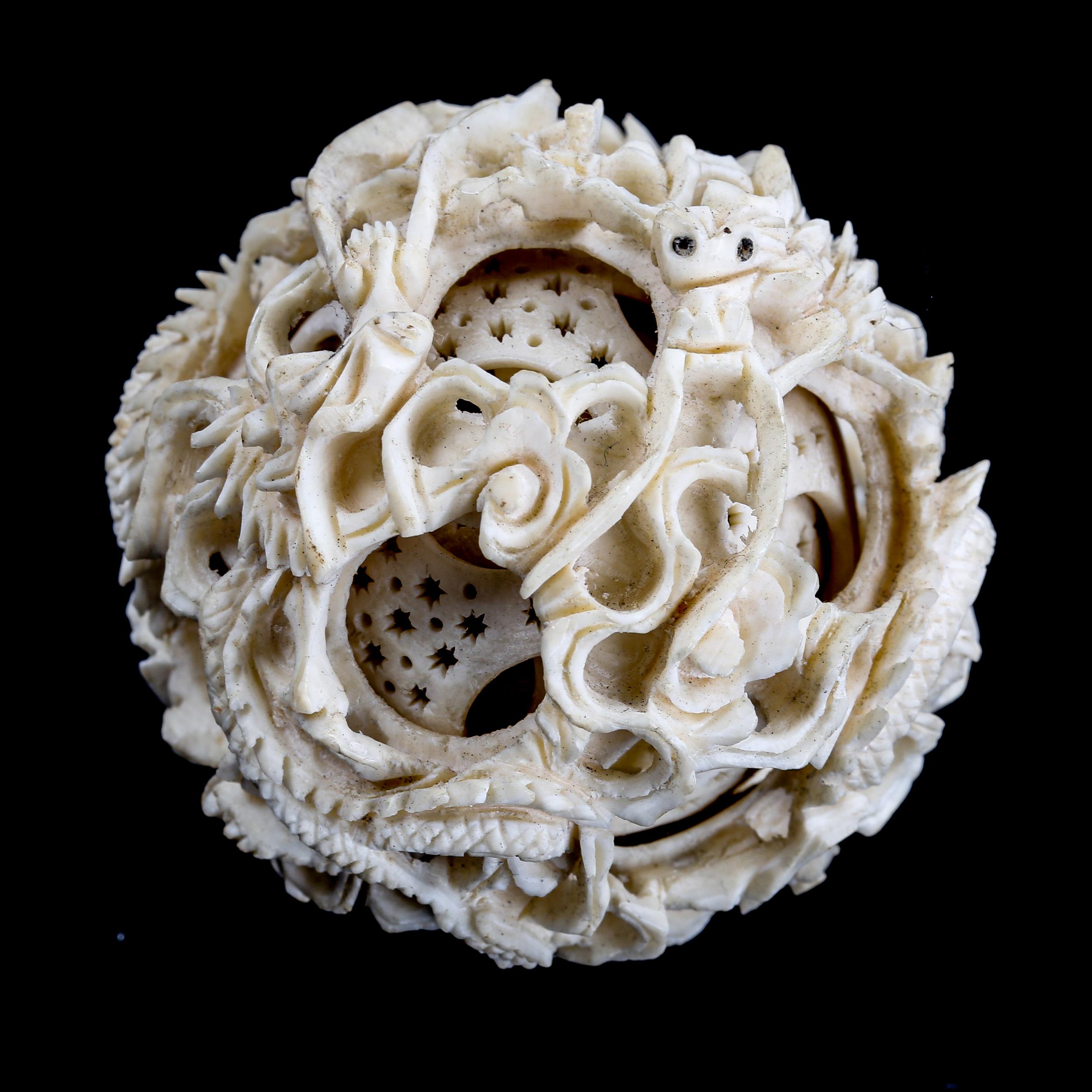 A Chinese carved ivory puzzle ball, late 19th/early 20th century, diameter 5cm