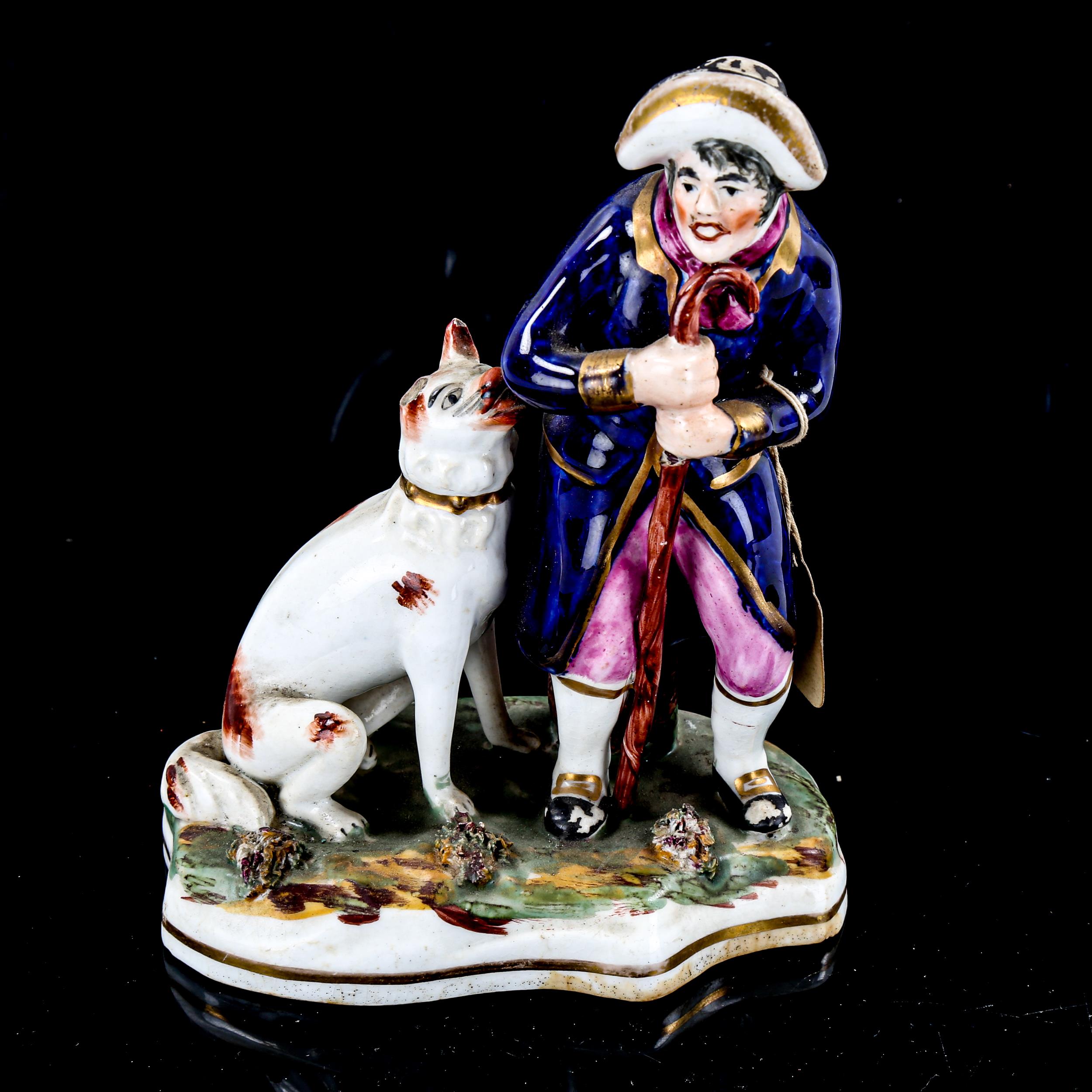 A 19th century Staffordshire porcelain figure of a man with a dog, height 15cm