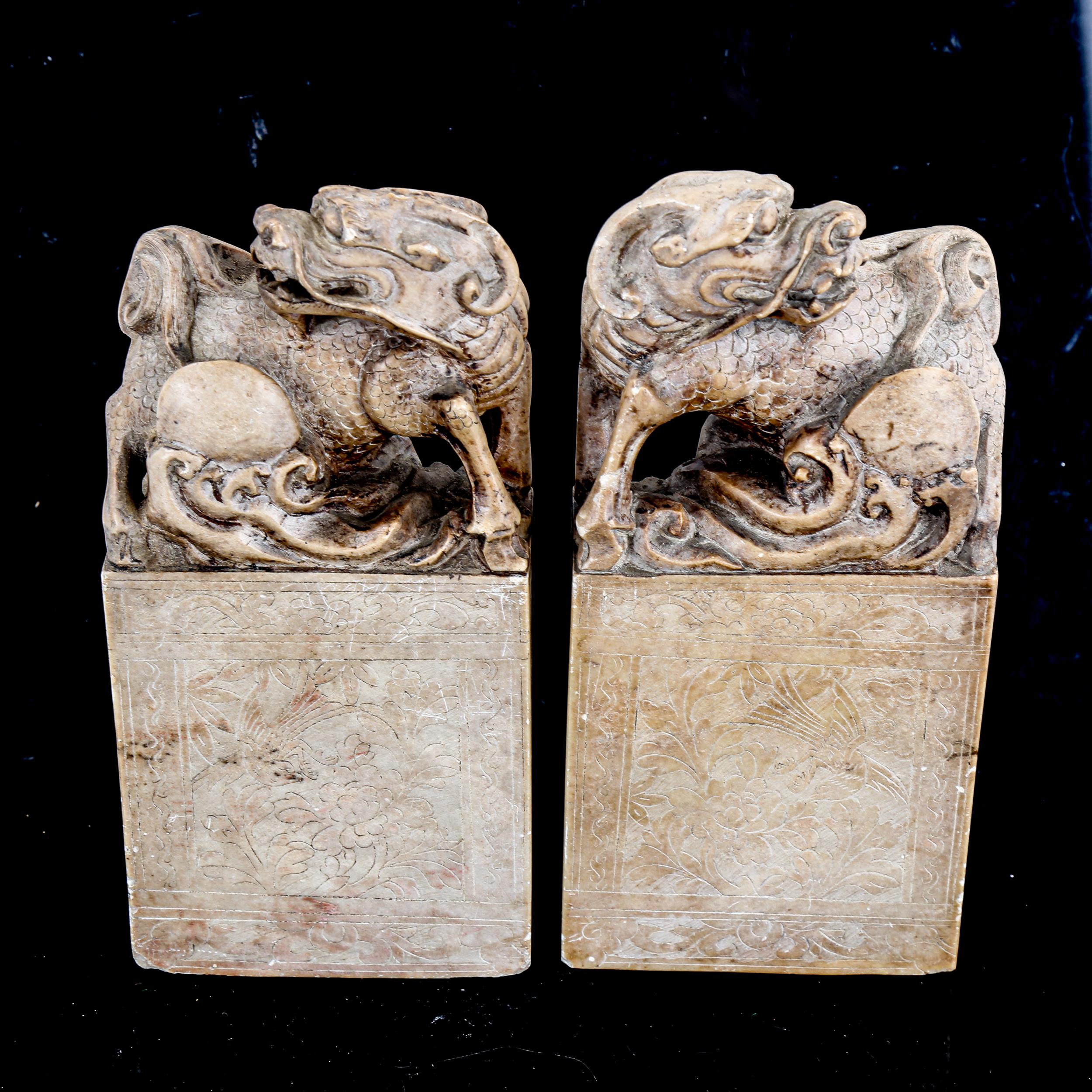 A pair of Chinese soapstone seals, surmounted by Dogs of Fo, height 18cm