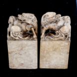 A pair of Chinese soapstone seals, surmounted by Dogs of Fo, height 18cm