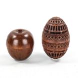A miniature turned wood apple, containing a miniature domino set, height 4.5cm, and a carved and