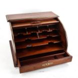 A mahogany tambour-front desktop stationery cabinet, circa 1900, with applied brass banding and