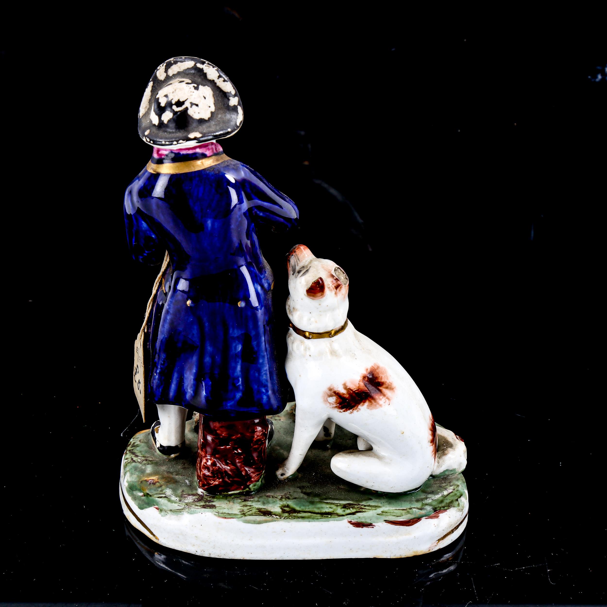 A 19th century Staffordshire porcelain figure of a man with a dog, height 15cm - Image 2 of 3