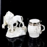 A Continental white glaze porcelain figure of a heraldic lion holding a sword, height 13cm, and a