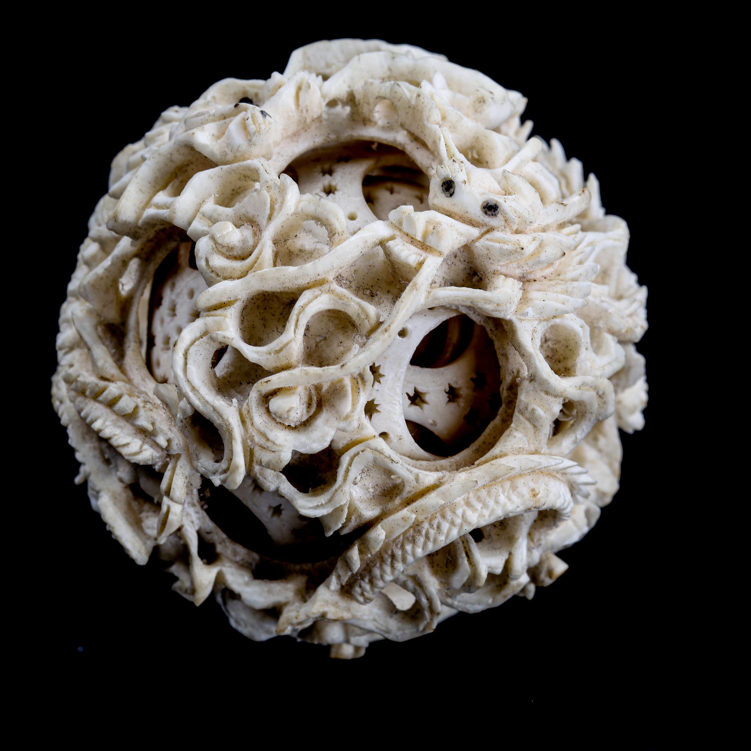 A Chinese carved ivory puzzle ball, late 19th/early 20th century, diameter 5cm - Image 2 of 3