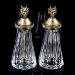 A pair of small cut-glass perfume bottles, with plated Pan head mounted lids with attached spoons,