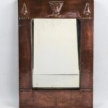 A Liberty & Co, Arts and Crafts mirror, with planished copper frame, label on reverse, 46 x 30.5cm