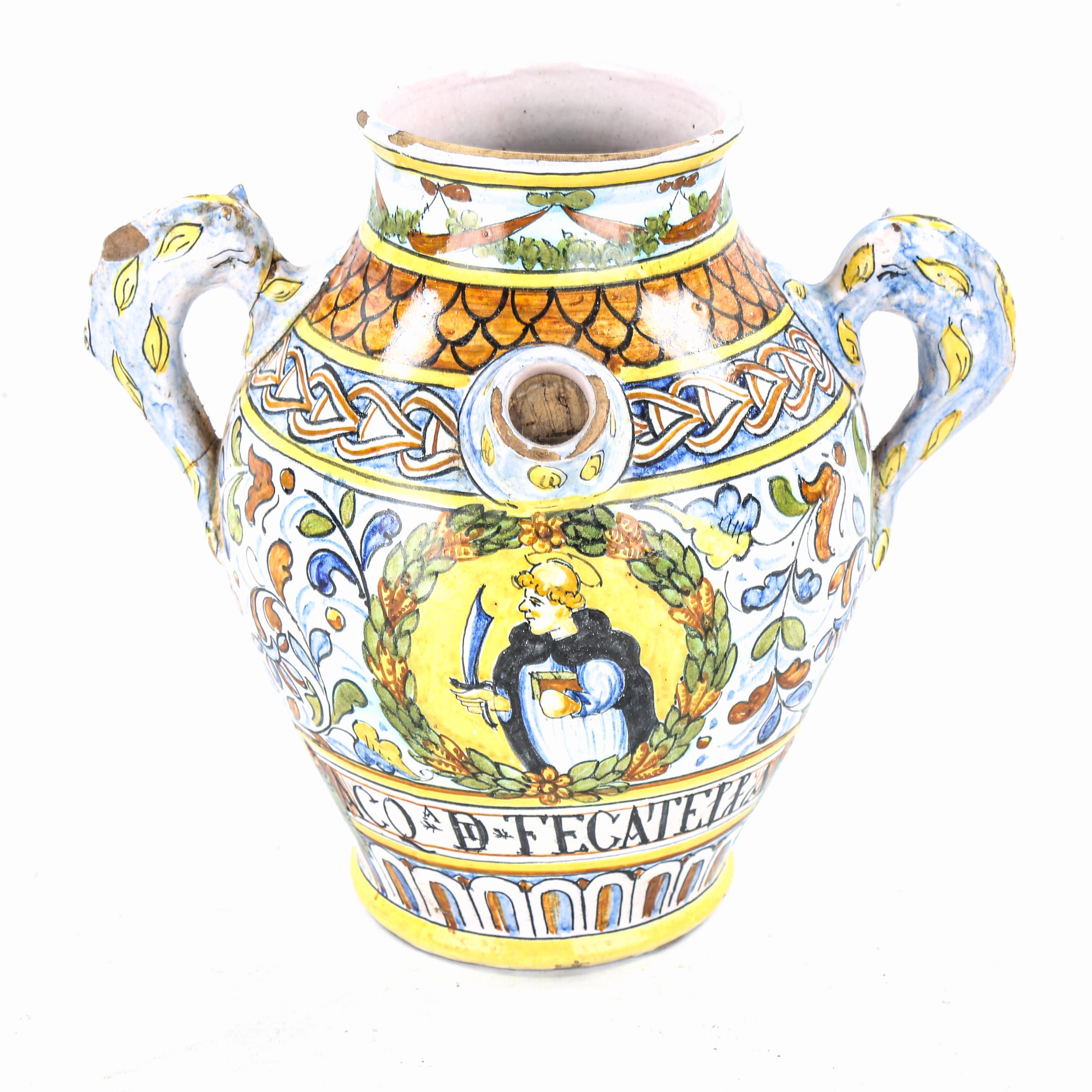 An Italian tin-glazed pottery wine vessel, with painted decoration and spout, height 22cm