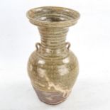 A Chinese Han Dynasty Hu form vase with ring handles, height 27cm, rim diameter 14cm