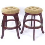 A pair of upholstered bar stools, with brass foot mounts, H75cm