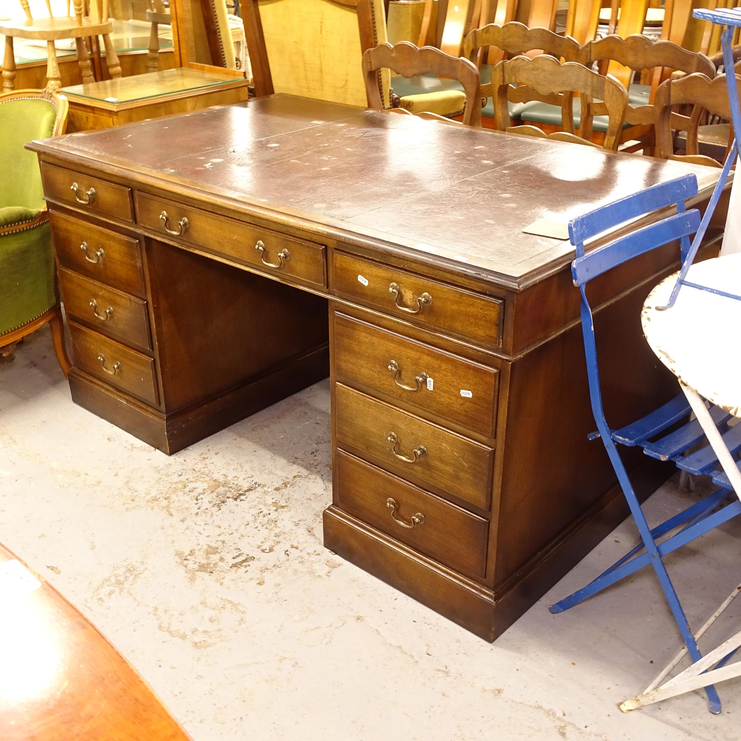 A mahogany twin-pedestal writing desk with fitted drawers, W153cm, H76cm, D91cm, kneehole width