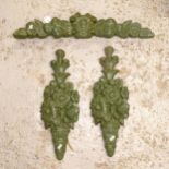 A pair of green painted plaster floral design wall mounts, L52cm, and similar pediment, L67cm