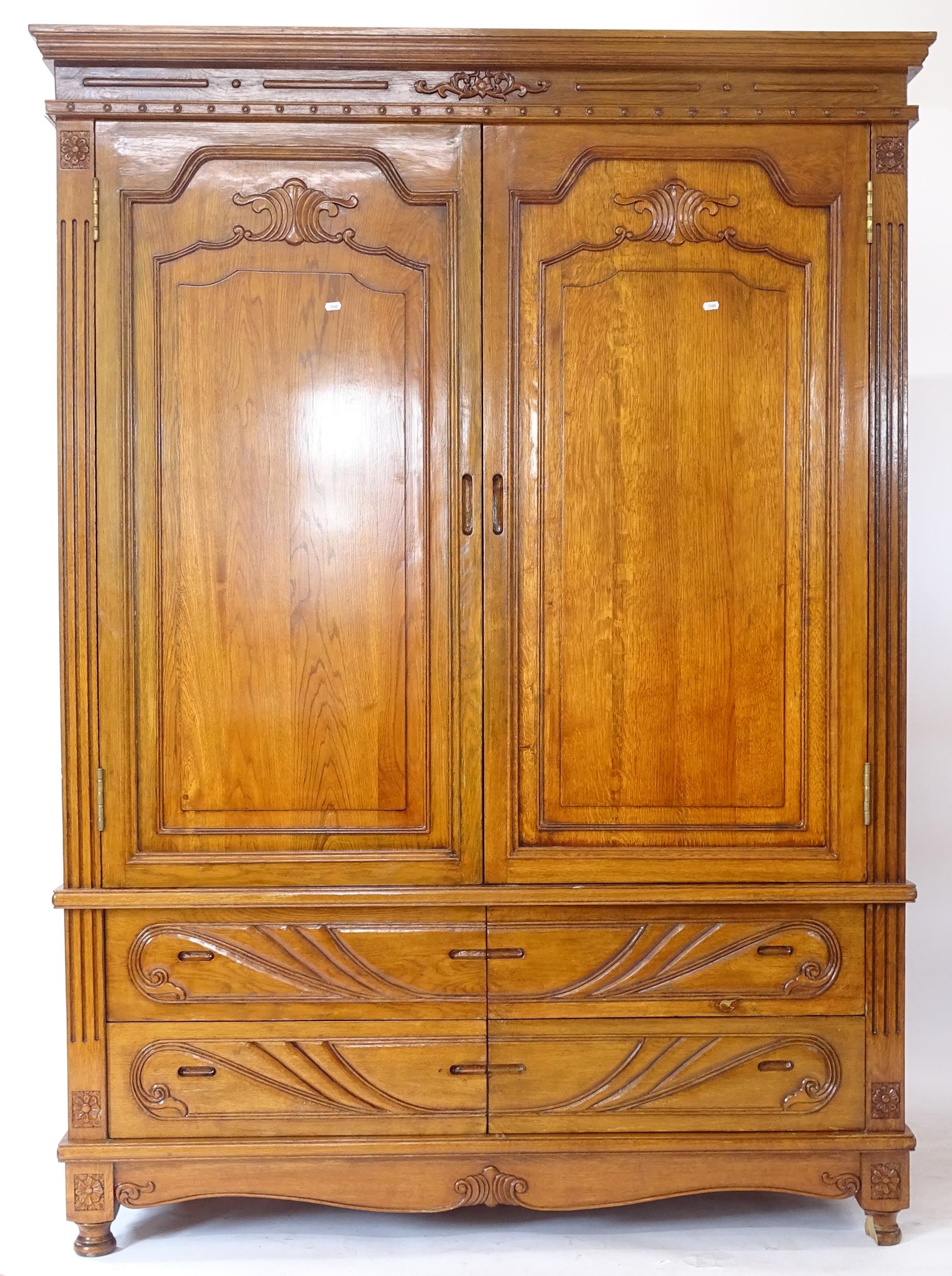 A modern carved oak 2-door wardrobe, with drawer-fitted base, W147cm, H230cm, D61cm (A/F) (WITH