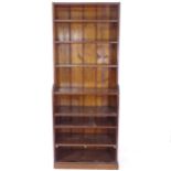 A stained pine open-front waterfall bookcase, W77cm, H195cm, D37cm