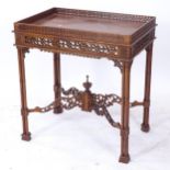 A reproduction mahogany silver table in Chippendale style, with a carved and pierced frieze cross