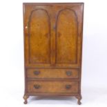 A 1930s walnut 2-door compactum, W74cm, H134cm, D49cm