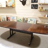 A mid-century Danish rosewood extending dining table, with 2 additional leaves