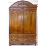 A modern carved oak 2-door wardrobe, with drawer-fitted base, W147cm, H230cm, D61cm (A/F)