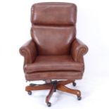 A studded brown leather swivel office chair, by Seven Seas Seating