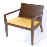 A contemporary mid-century style ply low armchair