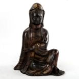 A Chinese patinated seated figure of Guanyin, height 21cm