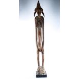 An African carved wood standing Tribal fertility figure, height 142cm Both of the side horn mounts