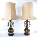 A pair of Chinese gilt-bronze table lamps, with cast dragon design handles and engraved birds and
