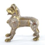 An Islamic bronze standing lion, possibly a lamp base, with inlaid silver and copper decoration