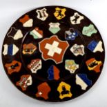 A Continental pottery charger, decorated with Coats of Arms, diameter 45cm