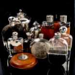 A collection of hip flasks and spirit flasks, including some silver