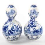 A pair of Japanese blue and white porcelain double-gourd vases, with hand painted decoration and