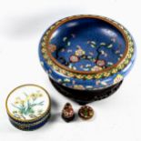 A Japanese blue ground cloisonne enamel bowl, with prunus tree decoration, diameter 20cm, on wood