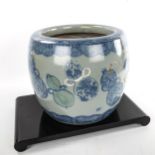 A large Japanese blue and white barrel-shaped planter, decorated with ceramics, height 26cm, rim