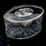 A cut-glass and unmarked white metal mounted oval box, length 12cm, height 8cm