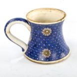 A Turkish pottery mug, with painted flowers on blue scale ground, height 11cm Very good condition