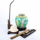 A group of Oriental items, including a relief moulded jar on stand, height 26cm, a brass opium pipe,