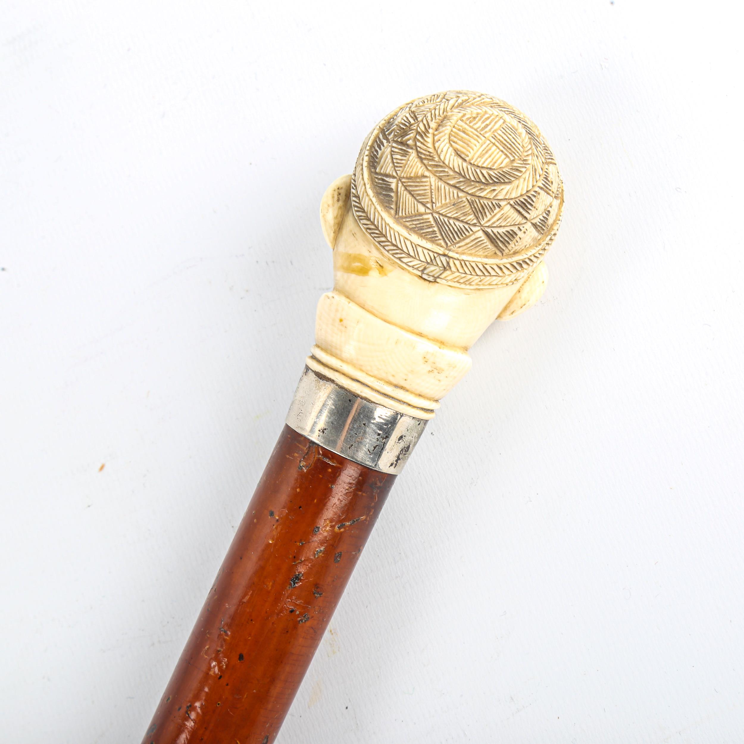 A malacca walking cane with African carved ivory head design handle, Continental silver collar, - Image 2 of 3