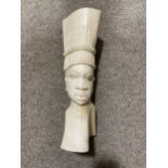 An African head of a man carved from an elephants thigh bone, circa 1930/40, height 34cm