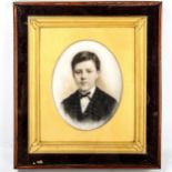 A Victorian watercolour on opaque glass, portrait of a boy, gilt-framed in outer cabinet case,