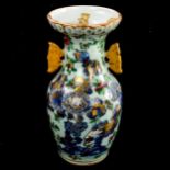 A Chinese celadon porcelain vase, with painted and gilded decoration, height 21.5cm 1 handle has