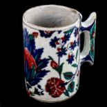 A Turkish pottery pint mug, with painted enamel decoration, height 13cm Top rim is unglazed, no sign