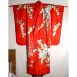 A Japanese wedding kimono, red silk ground with gold and silver embroidered wirework decoration,
