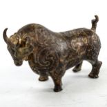 A gilt patinated bronze bull, with relief moulded surface decoration, length 18cm