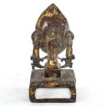 A Chinese verdigris bronze shrine, surmounted by Buddha figures, height 17cm