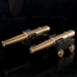 A pair of bronze barrelled table cannons, on painted wood carriages with brass wheels,