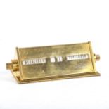 A Siemens polished brass-cased perpetual desk calendar of triangular form, length 11cm Good