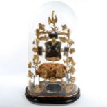 An ornate French gilt-metal and mirror inset marriage ornament, under original glass dome, overall