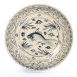 A Chinese blue and white ceramic bowl, with hand painted fish design, diameter 34cm There is an area