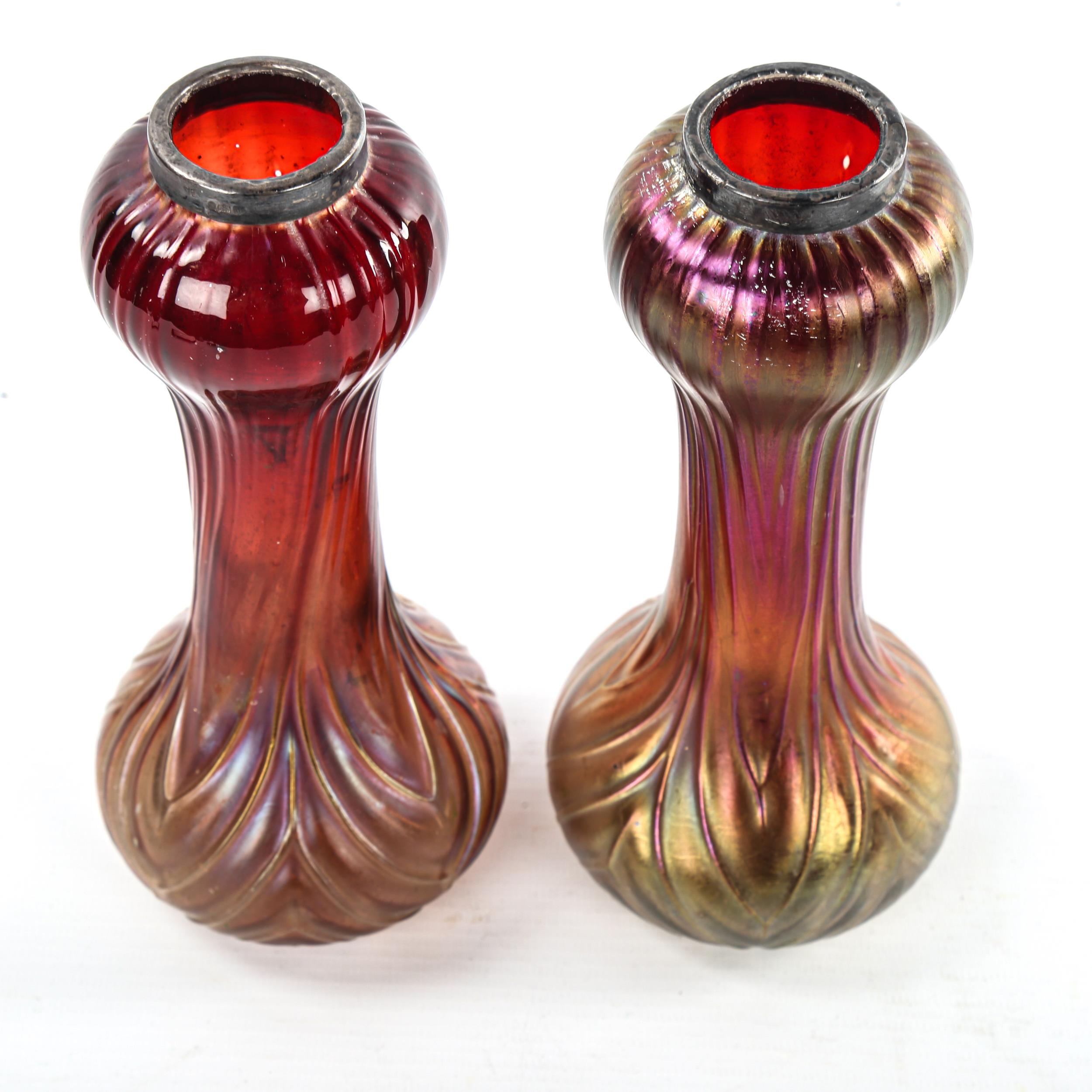 A pair of Loetz style iridescent red glass vases with moulded decoration, hallmarked silver rims, - Image 3 of 3