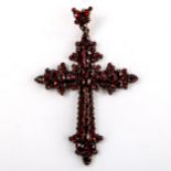 A Victorian Bohemian faceted garnet cross pendant, unmarked yellow metal settings, pendant height